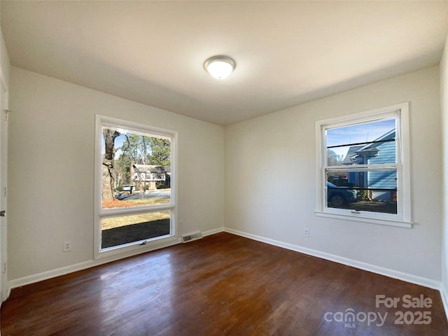 empty room with dark wood-type flooring