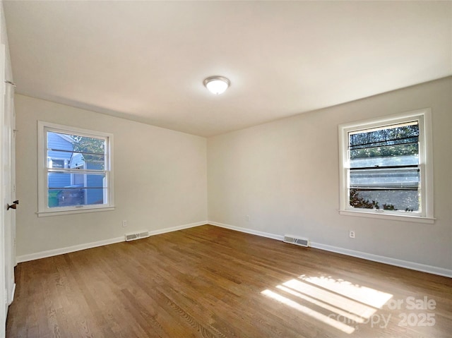 spare room with hardwood / wood-style floors