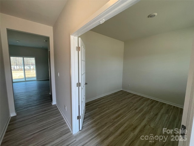 corridor with dark wood-type flooring