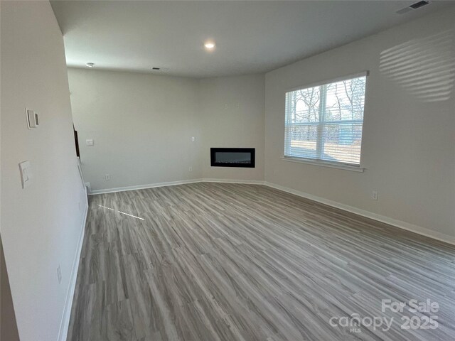 unfurnished living room with light hardwood / wood-style flooring