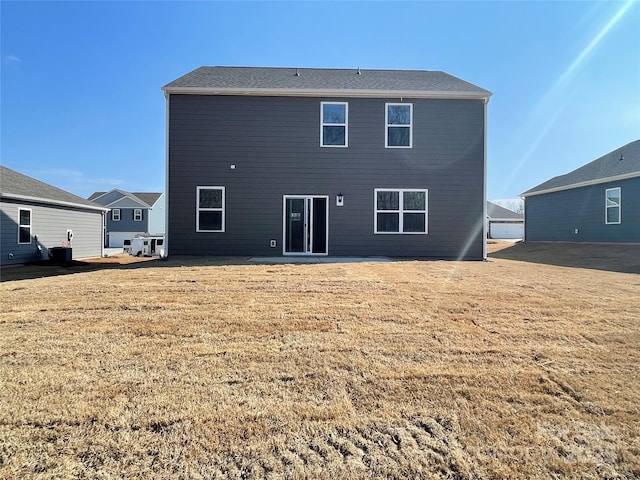 rear view of property with a lawn