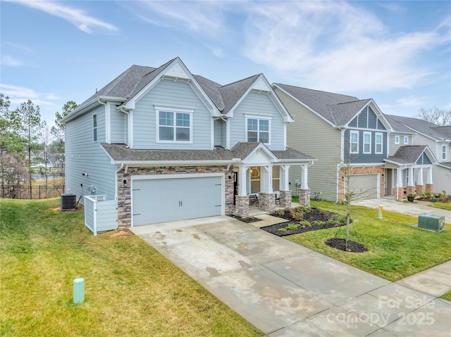 craftsman inspired home with a garage, a front lawn, and central air condition unit