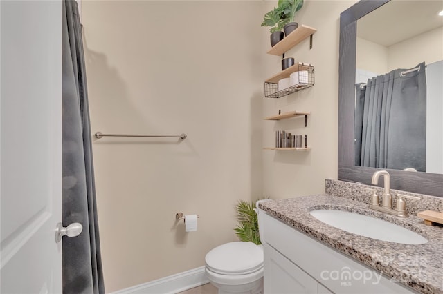 bathroom featuring vanity, toilet, and a shower with shower curtain