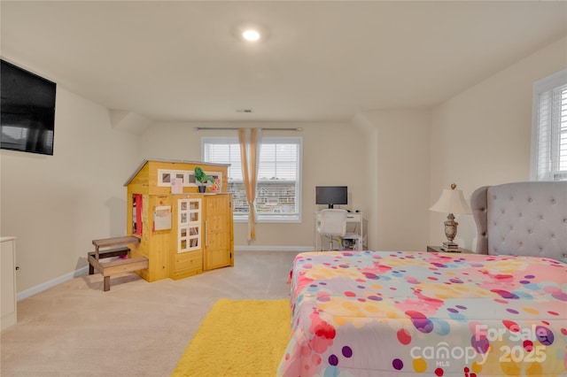 bedroom featuring multiple windows and light carpet