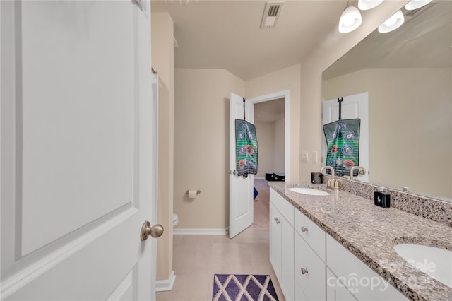 bathroom featuring tile patterned flooring, vanity, and toilet