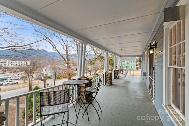 wooden terrace with a mountain view and a porch