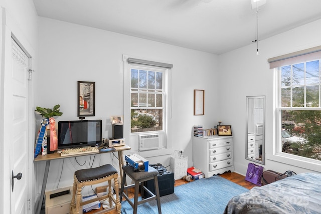 bedroom featuring hardwood / wood-style flooring and cooling unit