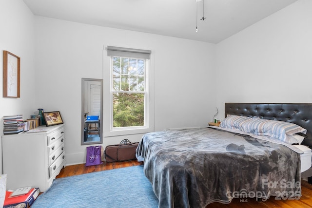 bedroom with hardwood / wood-style flooring