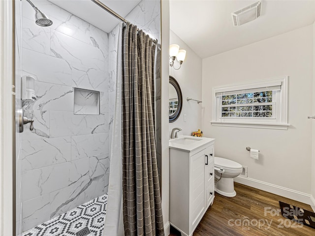 bathroom featuring vanity, hardwood / wood-style floors, a shower with curtain, and toilet