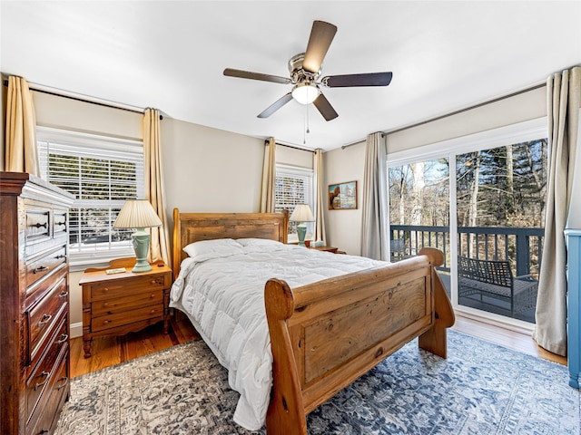 bedroom featuring access to exterior, hardwood / wood-style flooring, and ceiling fan