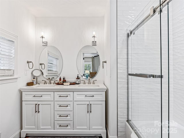 bathroom with vanity and combined bath / shower with glass door