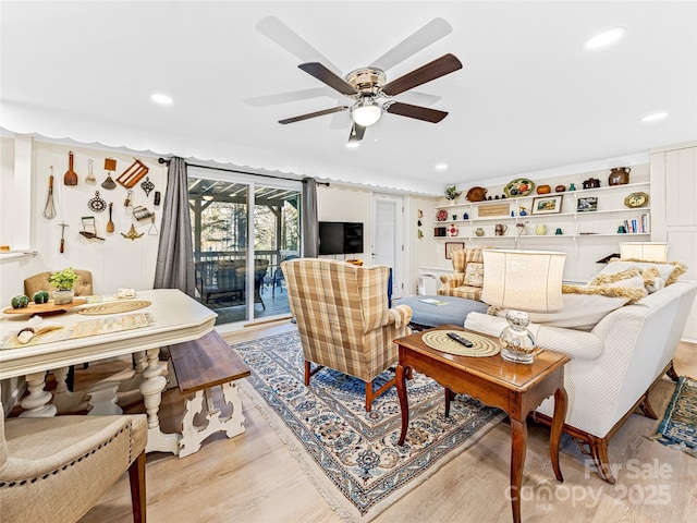 living room featuring ceiling fan and light wood-type flooring