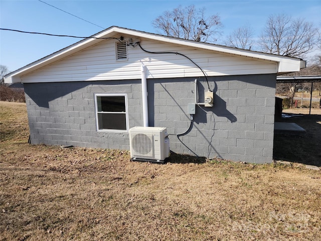 view of side of home featuring a yard and ac unit