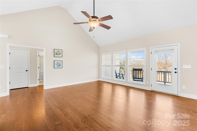 unfurnished living room with wood-type flooring, ceiling fan, and high vaulted ceiling