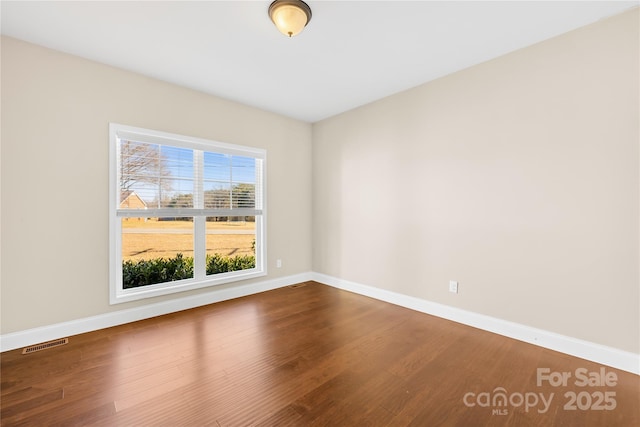 unfurnished room featuring wood-type flooring