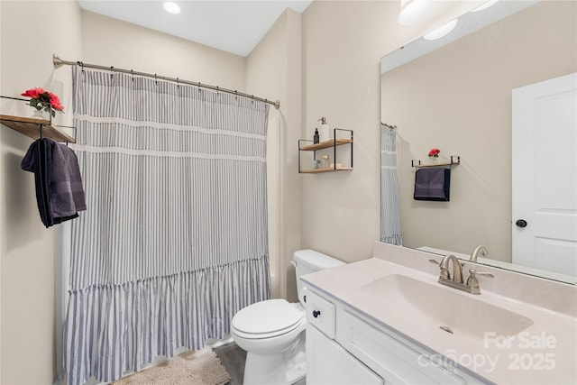 bathroom featuring vanity, a shower with curtain, and toilet