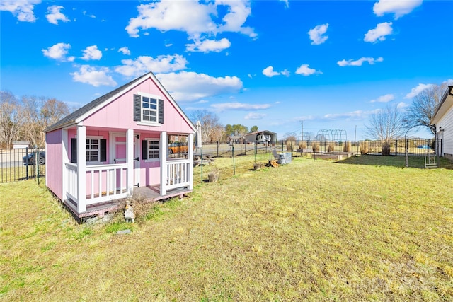 exterior space with an outdoor structure and a yard