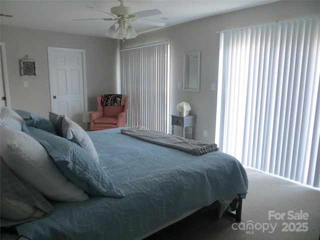 bedroom with ceiling fan, carpet floors, and multiple windows