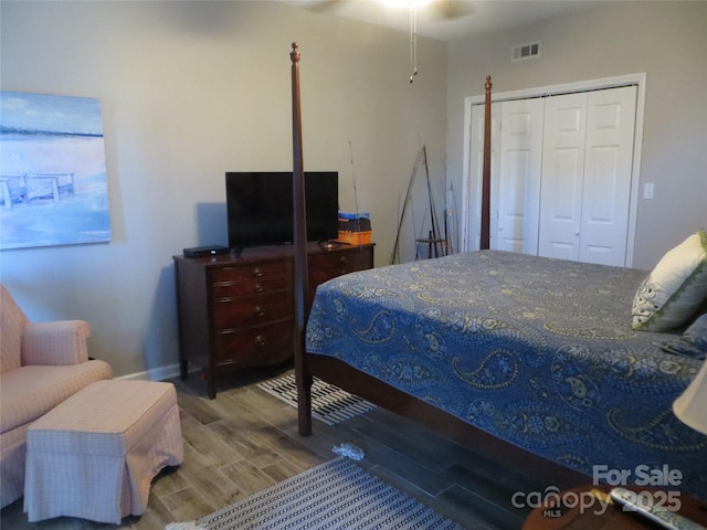 bedroom featuring wood-type flooring and a closet