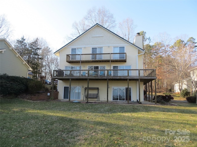 rear view of property featuring a wooden deck and a yard