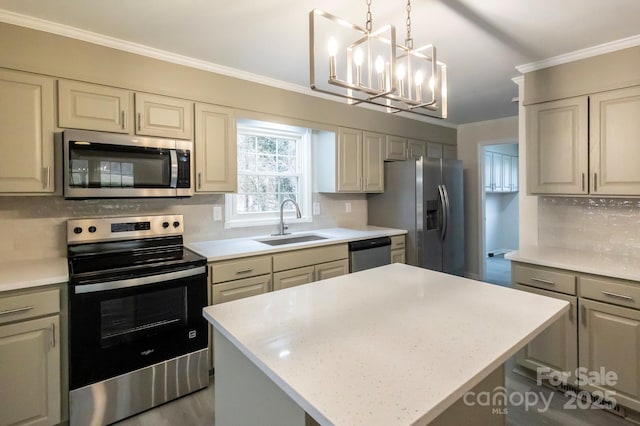 kitchen with a kitchen island, appliances with stainless steel finishes, sink, hanging light fixtures, and ornamental molding