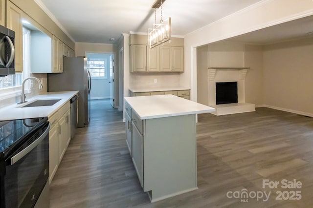 kitchen featuring sink, dark hardwood / wood-style flooring, hanging light fixtures, ornamental molding, and a center island