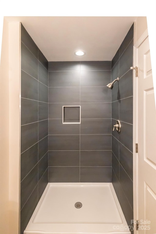 bathroom with tiled shower