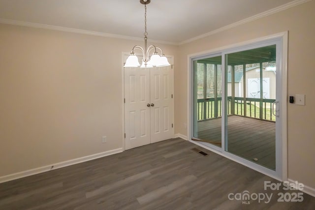 unfurnished dining area with ornamental molding, dark hardwood / wood-style floors, and a notable chandelier