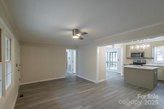unfurnished living room with crown molding, a ceiling fan, baseboards, wood finished floors, and visible vents