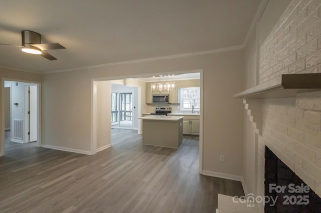 unfurnished living room featuring dark wood-style flooring, crown molding, a fireplace, a sink, and baseboards