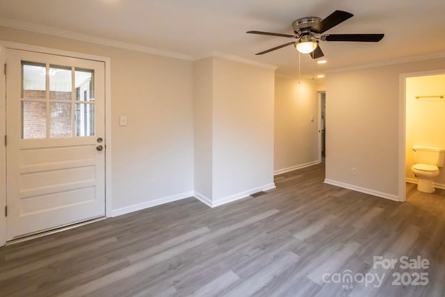 spare room featuring crown molding, baseboards, dark wood-type flooring, recessed lighting, and a ceiling fan