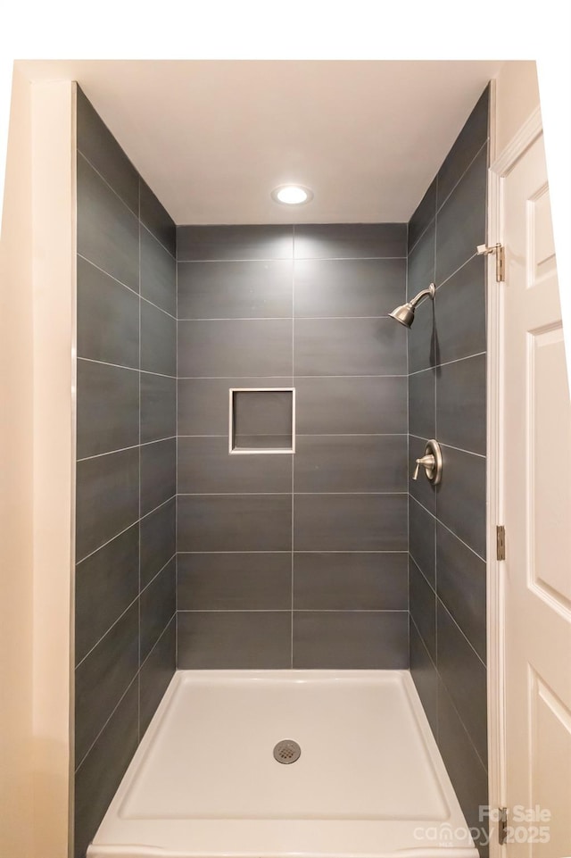 bathroom with a shower stall and recessed lighting