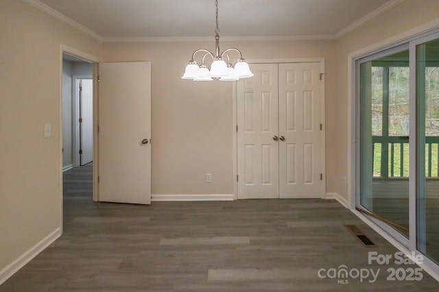 unfurnished dining area featuring baseboards, a notable chandelier, wood finished floors, and a wealth of natural light