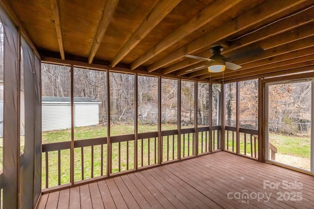 unfurnished sunroom featuring ceiling fan