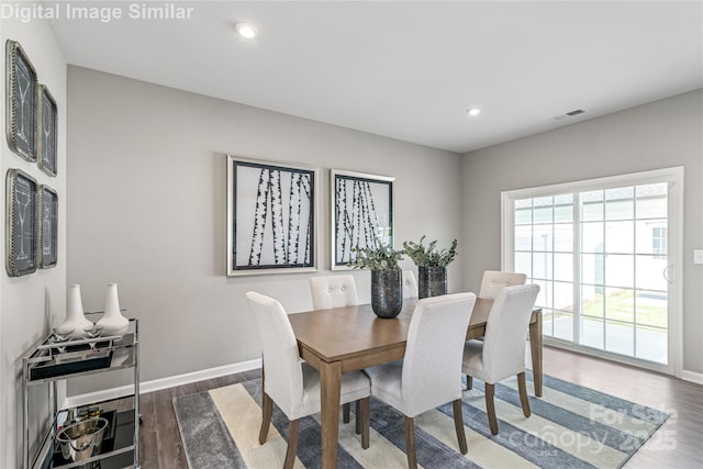 dining space with dark hardwood / wood-style flooring