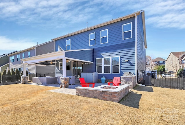 back of property with a lawn, central air condition unit, a patio area, and an outdoor living space with a fire pit