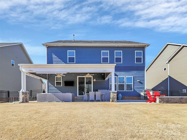 back of property featuring a yard, a patio, and ceiling fan