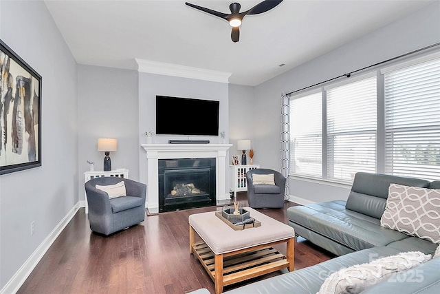 living room with ceiling fan, ornamental molding, and dark hardwood / wood-style flooring