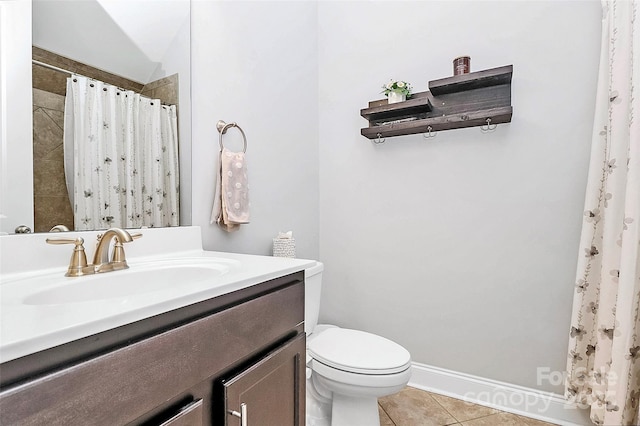 bathroom with tile patterned flooring, vanity, toilet, and walk in shower