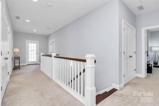 hallway with light carpet