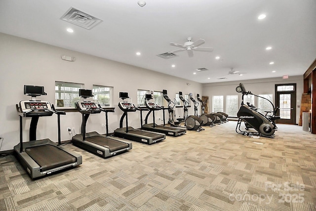 exercise room with ceiling fan and light colored carpet