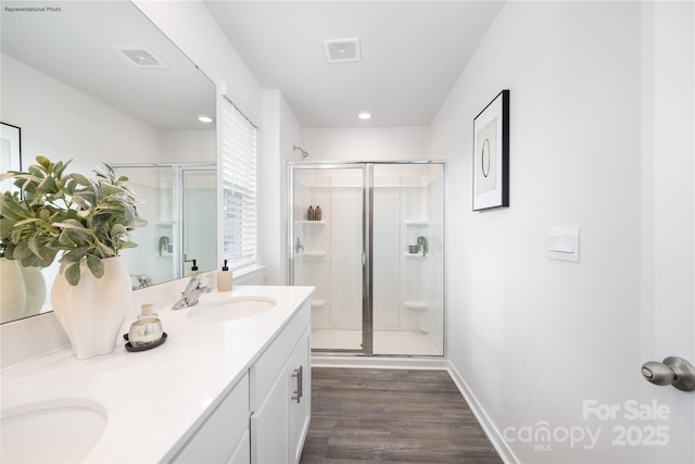 bathroom featuring vanity, a shower with door, and hardwood / wood-style floors