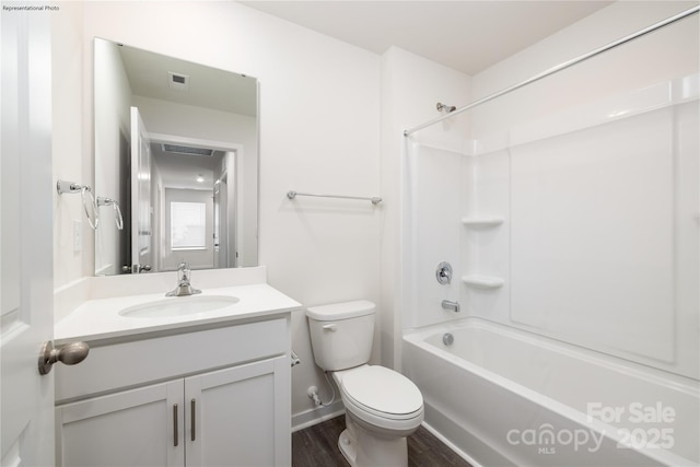 full bathroom with hardwood / wood-style flooring, shower / bathtub combination, vanity, and toilet