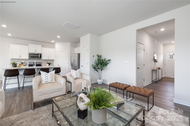 living room with dark hardwood / wood-style floors