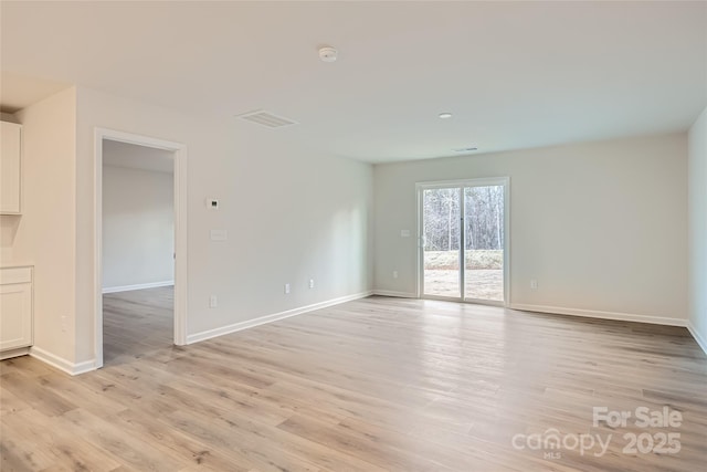 unfurnished room with light hardwood / wood-style flooring