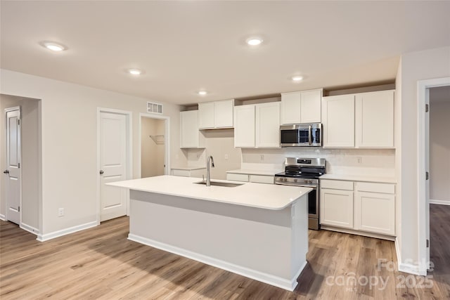 kitchen with white cabinetry, stainless steel appliances, and sink