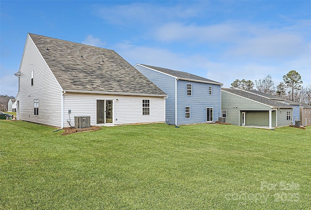 rear view of house featuring a yard and central air condition unit