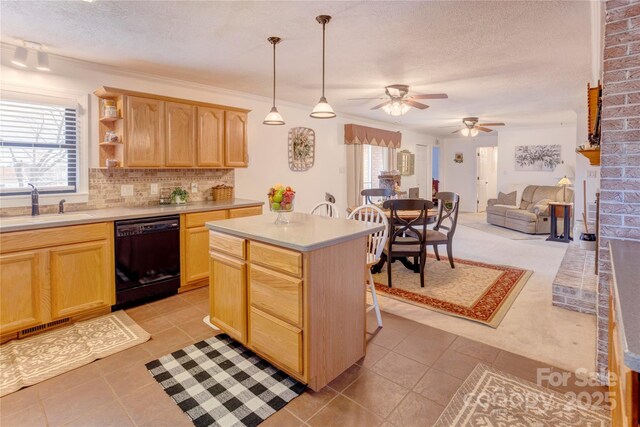 kitchen with black dishwasher, a healthy amount of sunlight, a sink, and light brown cabinetry