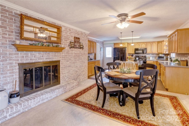 dining space featuring a fireplace, light colored carpet, ornamental molding, a ceiling fan, and a textured ceiling