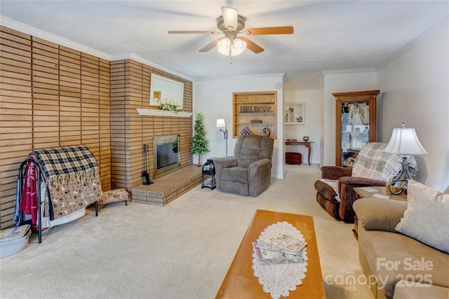 carpeted living room featuring ornamental molding, a fireplace, and a ceiling fan